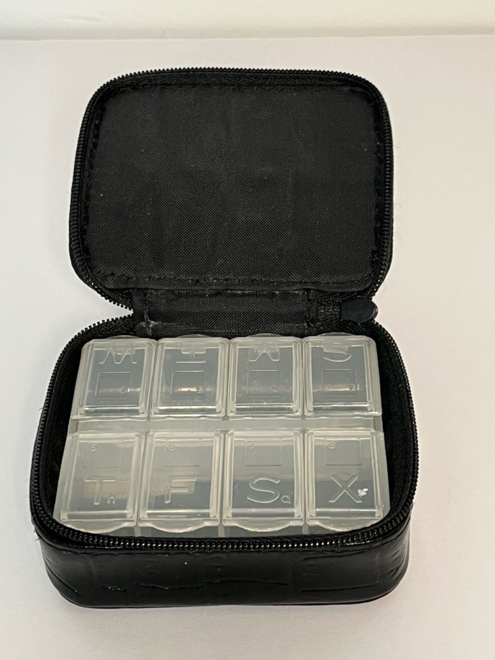 Compact Black Pill Organizer Case with 8 Labeled Compartments